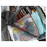 Collection of Quilting Fabrics and Patterns in Storage Bins