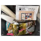 Collection of Quilting Fabrics and Patterns in Storage Bins