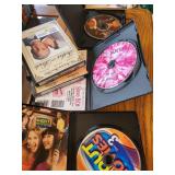 Collection of DVDs, Puzzles, and Storage Ottoman