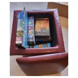 Collection of DVDs, Puzzles, and Storage Ottoman