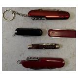 Pocket Knives - (1) Northern Plains Gunworks Red Multi Tool Pocket Knife (1) Integrity - Knife / Scissors (1) Small Swiss - Blade / scissors (1) Case - Brown Handle Pocket Knife (1) Red Multi Tool Poc