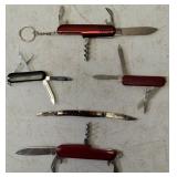Pocket Knives - (1) Northern Plains Gunworks Red Multi Tool Pocket Knife (1) Integrity - Knife / Scissors (1) Small Swiss - Blade / scissors (1) Case - Brown Handle Pocket Knife (1) Red Multi Tool Poc
