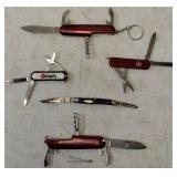 Pocket Knives - (1) Northern Plains Gunworks Red Multi Tool Pocket Knife (1) Integrity - Knife / Scissors (1) Small Swiss - Blade / scissors (1) Case - Brown Handle Pocket Knife (1) Red Multi Tool Poc