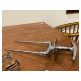 Lot of silverplate spoon, unmarked serving tong and carving piece.