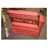 Antique Red Upholstered Chair with Ornate Wooden Frame and Cushions