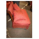 Antique Red Upholstered Chair with Ornate Wooden Frame and Cushions