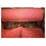 Antique Red Upholstered Chair with Ornate Wooden Frame and Cushions
