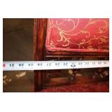 Antique Red Upholstered Chair with Ornate Wooden Frame and Cushions