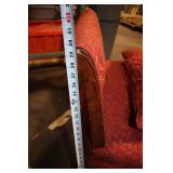 Antique Red Upholstered Chair with Ornate Wooden Frame and Cushions