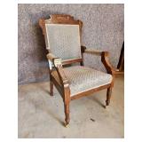 Cool ornate antique Chair with front side wheels and great detail