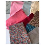 Collection of Assorted Fabric Pieces in Various Patterns and Colors