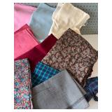 Collection of Assorted Fabric Pieces in Various Patterns and Colors