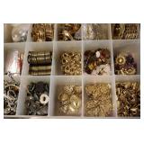 3 small organizers filled with tiny...