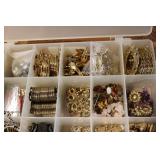 3 small organizers filled with tiny...