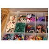 3 small organizers filled with tiny...