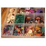 3 small organizers filled with tiny...