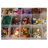 3 small organizers filled with tiny...