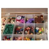 3 small organizers filled with tiny...