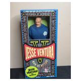 Collection of Decorative Hurricane Vase, Village Candle, and Jesse Ventura Action Figure