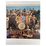 Four Beatle Albums in protective sleeve