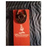 Vintage Budweiser bottle opener mounted on a Budweiser board