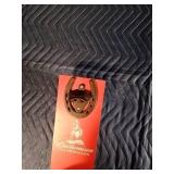 Vintage Budweiser bottle opener mounted on a Budweiser board