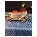 Vintage metal car with decanter and 4 shot glasses in it