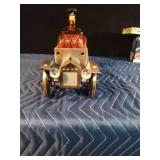 Vintage metal car with decanter and 4 shot glasses in it