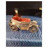 Vintage metal car with decanter and 4 shot glasses in it