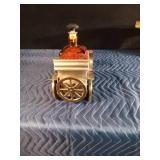 Vintage metal car with decanter and 4 shot glasses in it