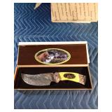 Hunting knife with bears on the handle and etching on the blade