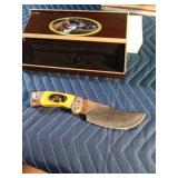 Hunting knife with bears on the handle and etching on the blade