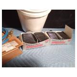 Pail of new auto body filler spreaders and 4" Brad hose