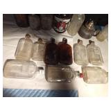 Vintage bottles and a growler and a lantern base