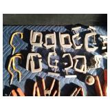 Pail of truck tie down clamps, spring clamps and more