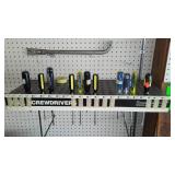 Assorted Screwdrivers with peg board organizer and Pry Bar.