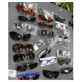 25 pair of adult sunglasses (a couple are readers)