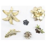 Group of 6  Gold Tone Base Metal Brooches.