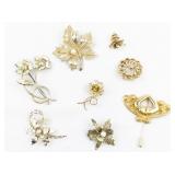 Group of 8 Gold Tone Base Metal Brooches.