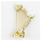 Rhinestone Accented Harp Gold Tone Base Metal Brooch .