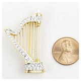 Rhinestone Accented Harp Gold Tone Base Metal Brooch .