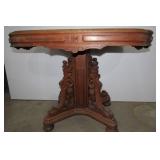 Wood table  heavily carved with mar...