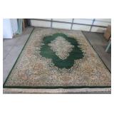 Large area rug, done in greens and ...