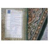 Large area rug, done in greens and ...