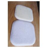 2 white seat cushions