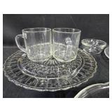 Set of Glass Dinnerware Pieces Including Plates and Mugs