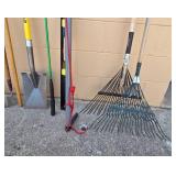 Collection of Yard and Garden Tools Including Rakes, Shovel, and Pole Pruner