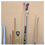 Collection of Yard and Garden Tools Including Rakes, Shovel, and Pole Pruner