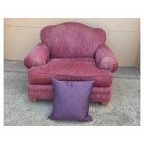 Cozy Plum-Colored Armchair with Decorative Pillow