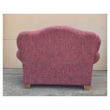 Cozy Plum-Colored Armchair with Decorative Pillow